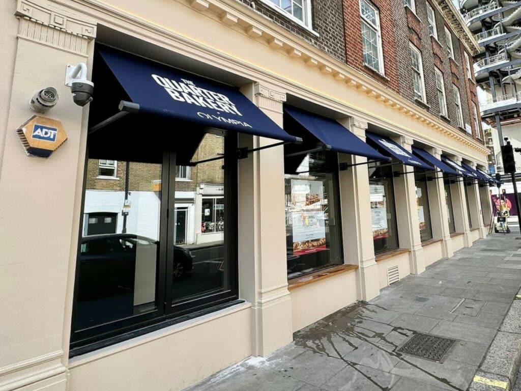 the quarter bakery olympia building with retractable awnings over each window